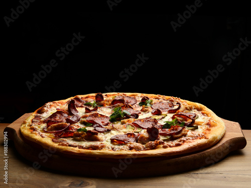 Pizza composition with melting cheese bacon tomatoes ham paprika