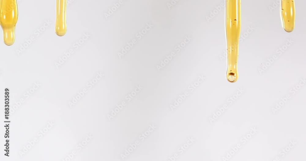 Close up golden sweet honey dripping line on the white background , 4K Dci resolution
