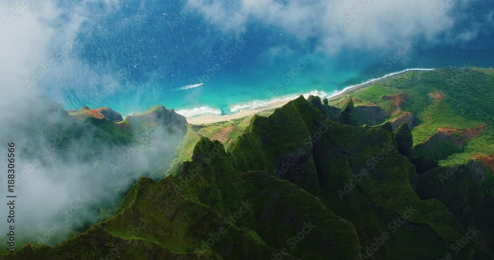Cinematic aerial view of dramatic mountains and ocean on Napali Coast, Kauai, Hawaii