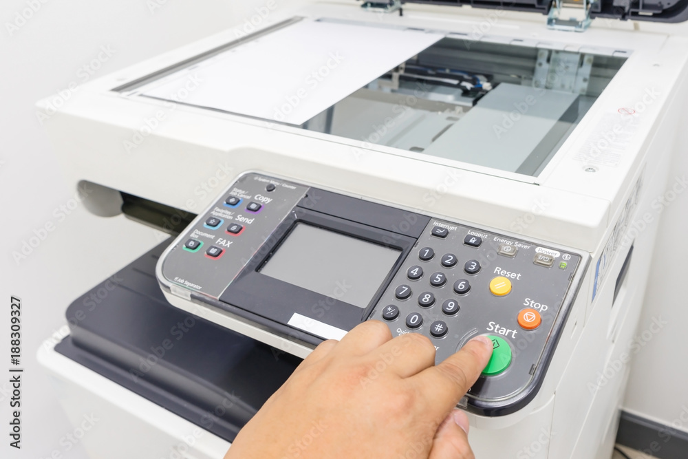 Man copying paper from Photocopier with access control for scanning key card Man copying paper from Photocopier with access control for scanning key card