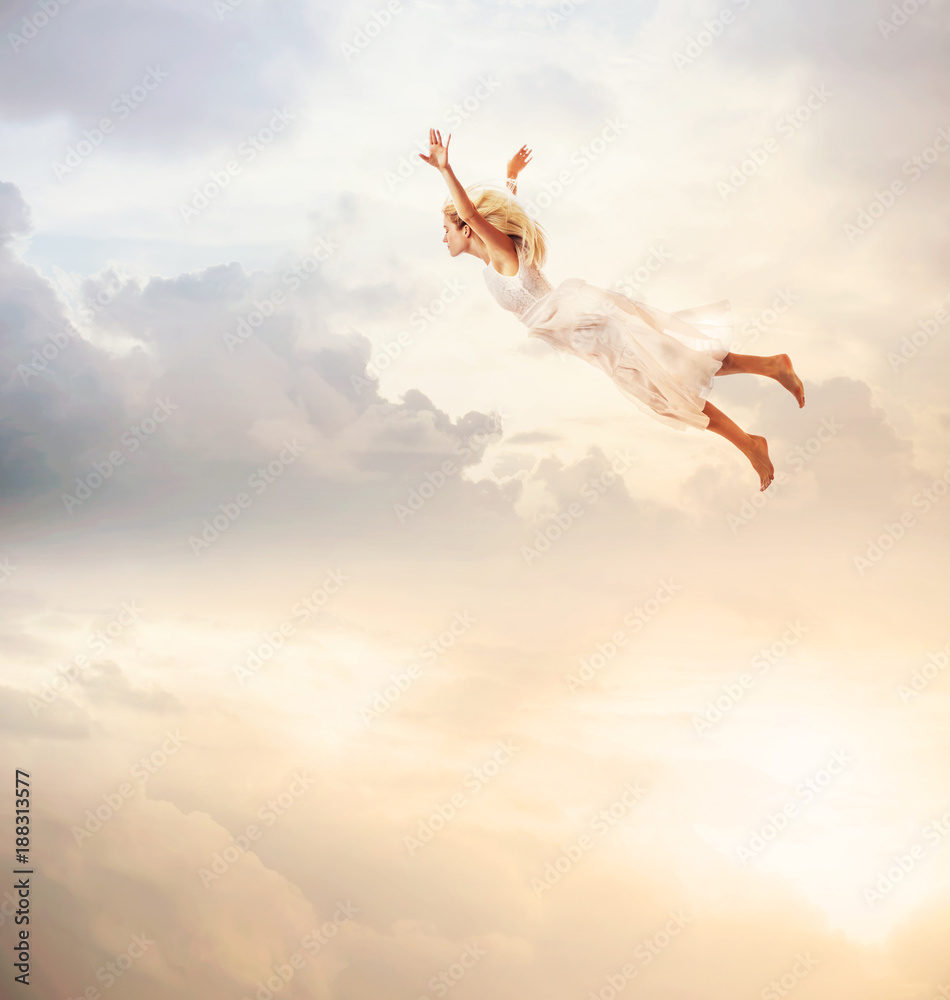 Woman in a white dress flying in the sky. Serenity Woman in a white dress flying in the sky. Serenity