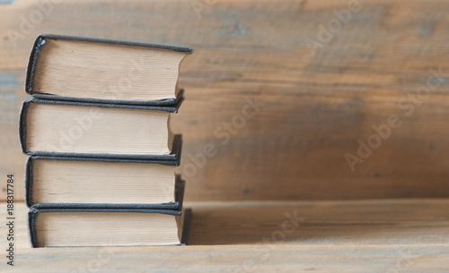 Old books on a wooden shelf.