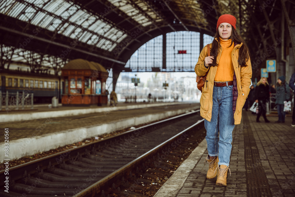 woman walk by railway station - obrazy, fototapety, plakaty 