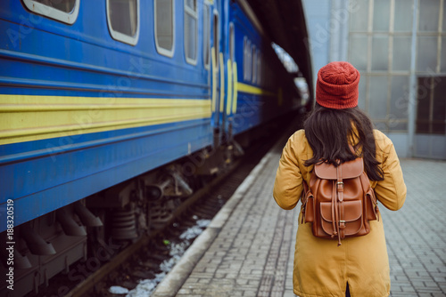 woman walk by railway station near train photo