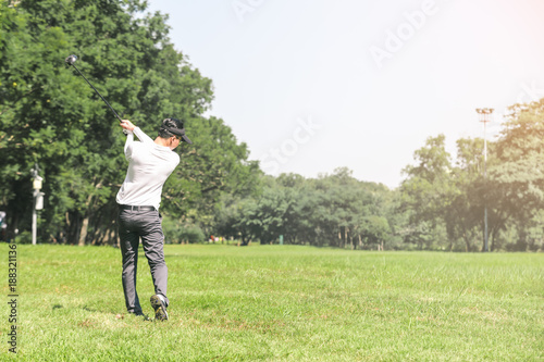 Asian men playing golf. men play golf while standing on field