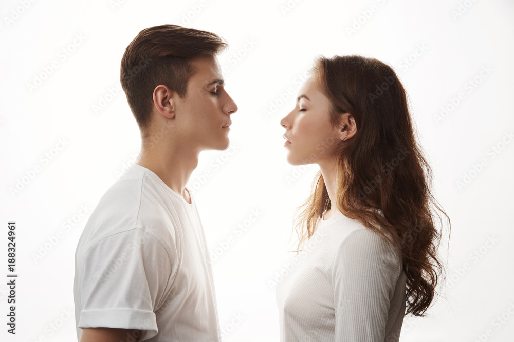 Couple standing face to face with their eyes closed. Boyfriend and