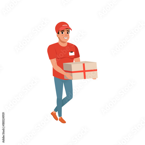 Delivery service worker with parcel in hands. Cartoon courier character in red t-shirt, cap and blue jeans. Cheerful young man carrying cardboard box. Flat vector design