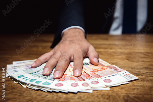 Businessman giving money, Russian Ruble banknotes