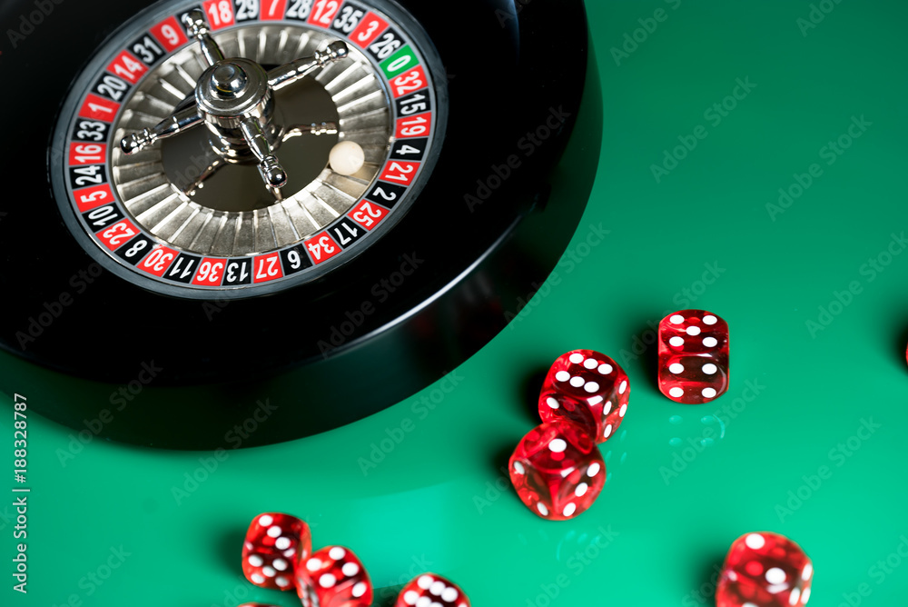 High contrast image of casino roulette and poker chips on bokeh background. High contrast image of casino roulette and poker chips on bokeh background.