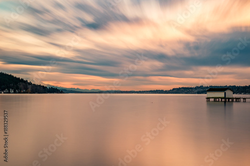 A long exposure of the sunset lighting up the cloudy sky over Lake Washington