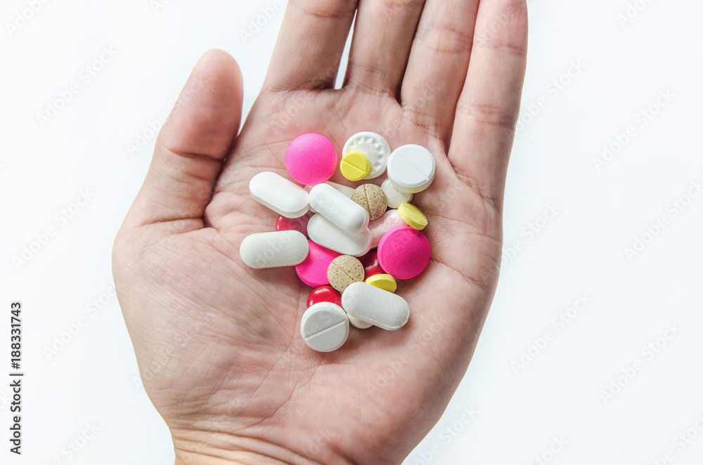 Top view of the pills on the hand and white background, A hand hold the pills and drug, Pile of the drug and pills on the hand. Top view of the pills on the hand and white background, A hand hold the pills and drug, Pile of the drug and pills on the hand.