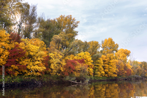landscape with river and autumn forest on the high bank.