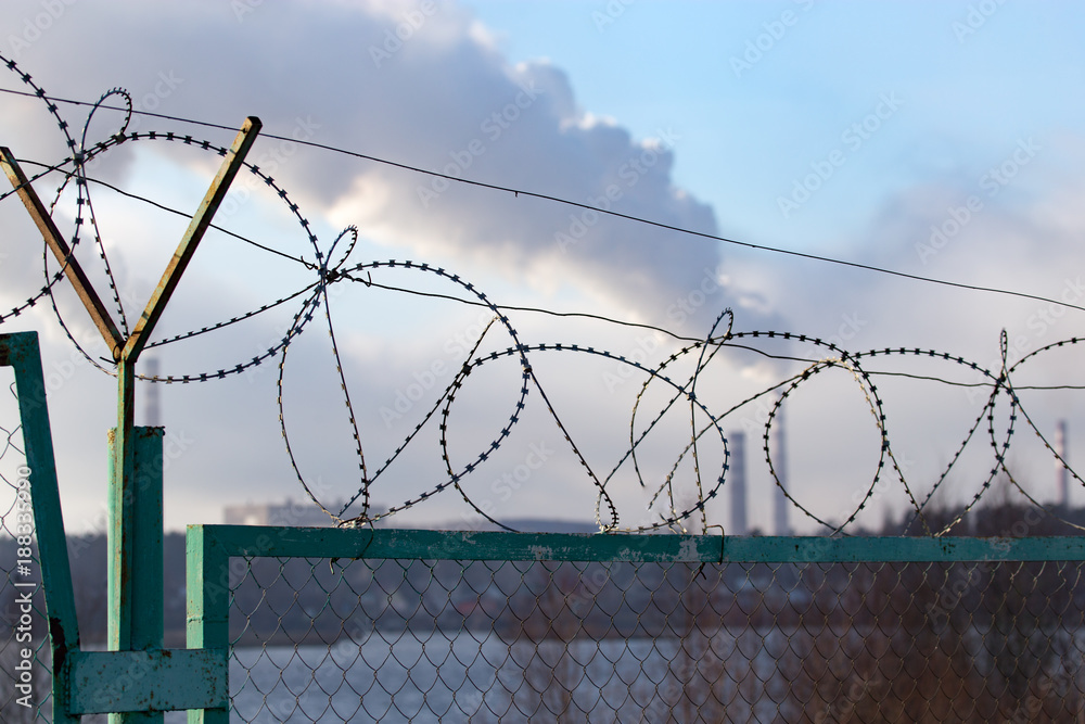Fence with barbed wire as a background Fence with barbed wire as a background