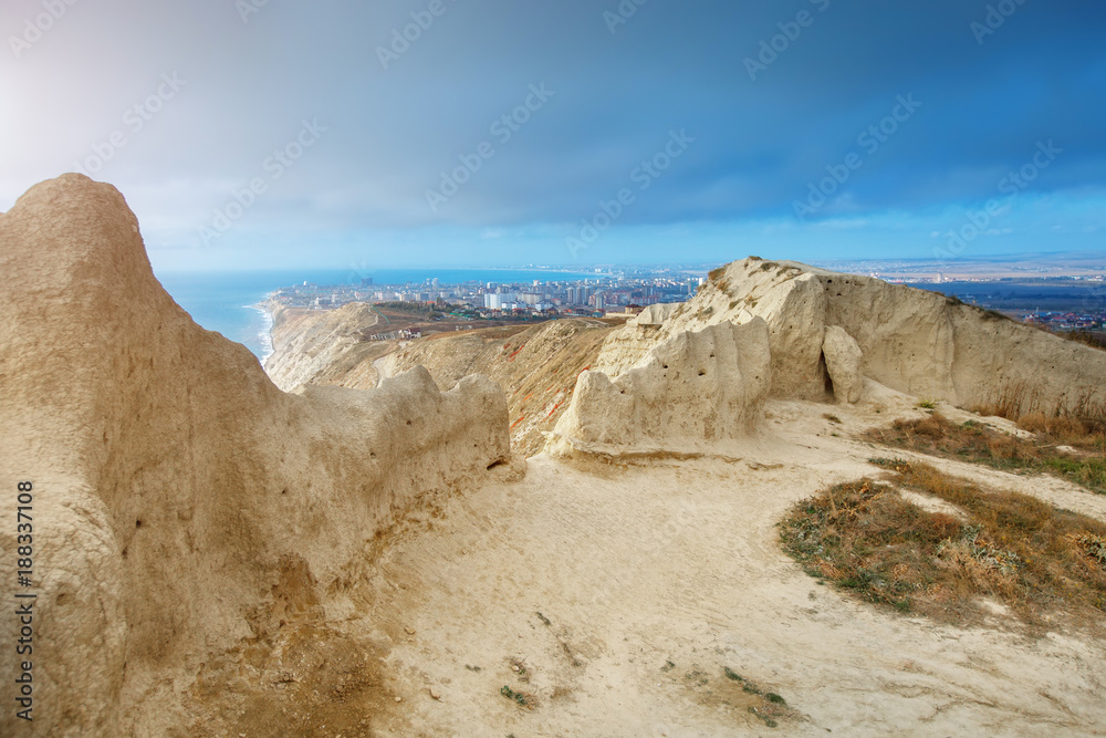 Mountains and a sea landscape with the blue sky. Black Sea, Russia. Beautiful view of the city. Mountains and a sea landscape with the blue sky. Black Sea, Russia. Beautiful view of the city.