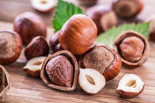 Hazelnuts and hazelnut leaves on the wooden table. photo