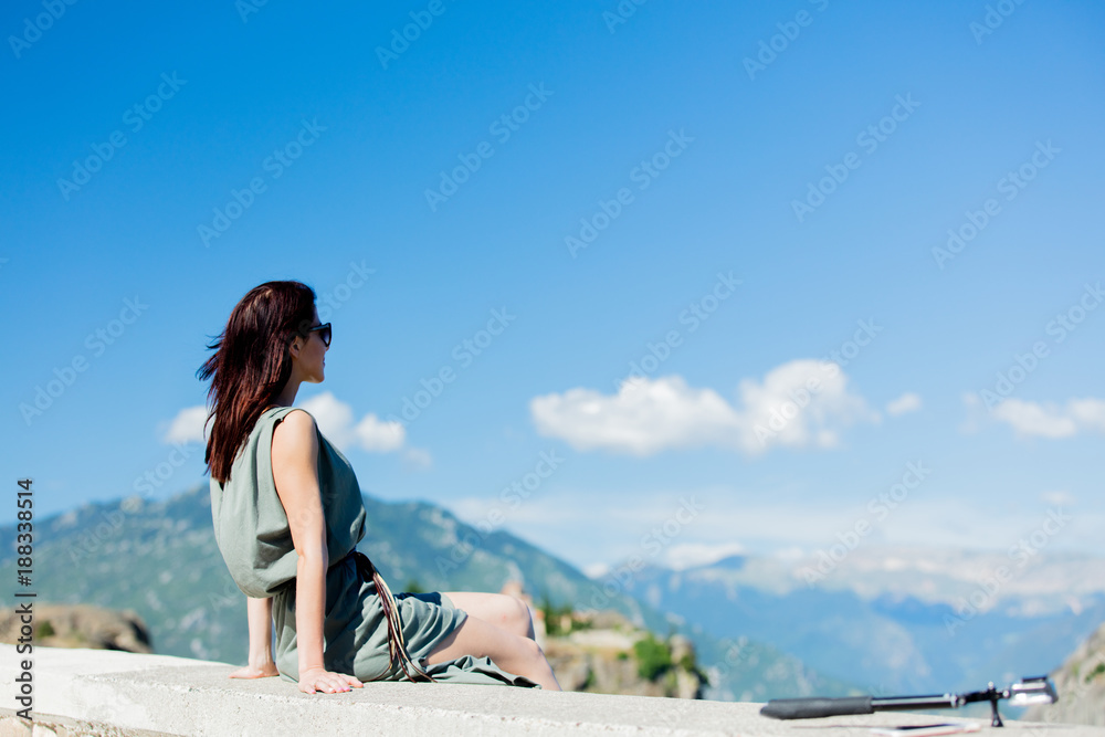 Woman sitting at precipice in Greece