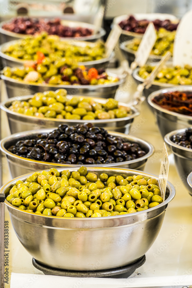 Different cured table olives in the bowls.