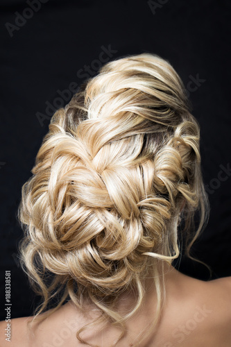 portrait of an attractive young woman with a wedding hairstyle. Back view.