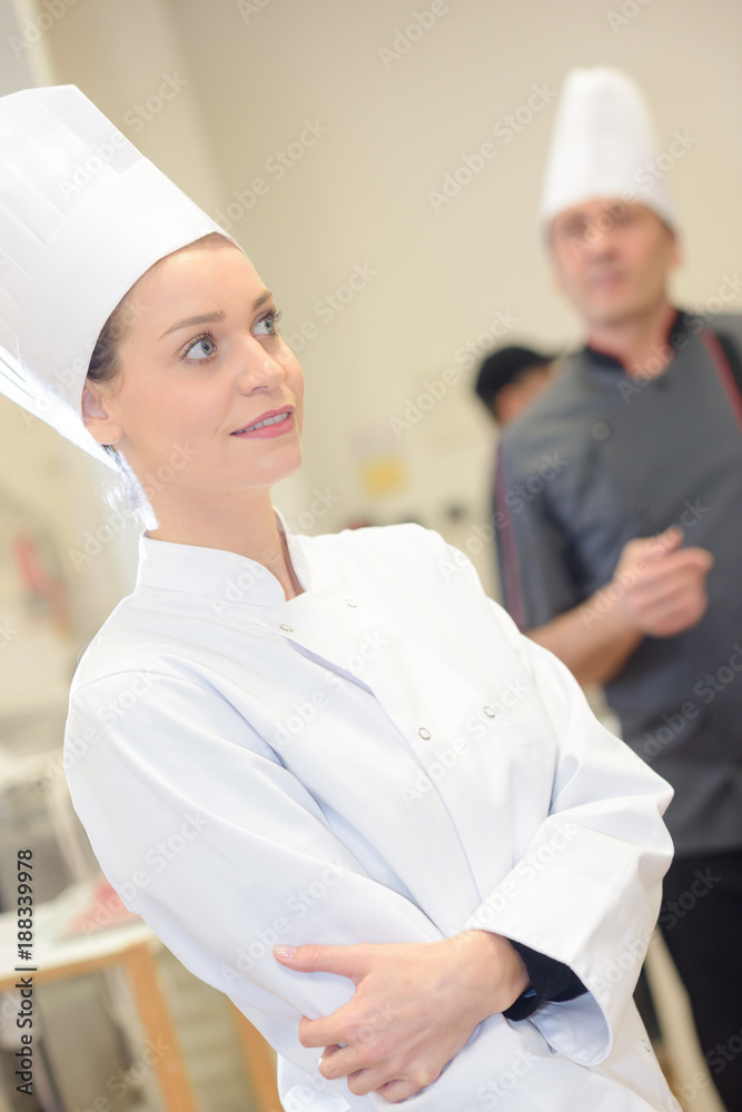 confident female chef in commercial kitchen