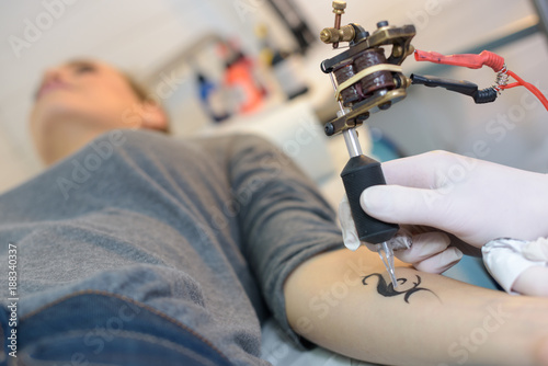 woman getting a small tattoo