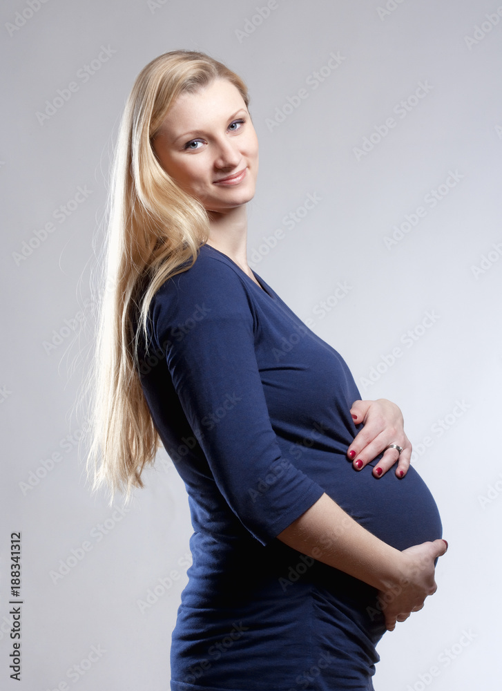 Pregnant Blond Woman in Blue Dress. Pregnant Blond Woman in Blue Dress.