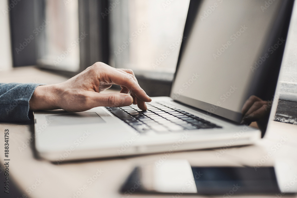 Businessman using laptop computer. Male hand typing on laptop keyboard Businessman using laptop computer. Male hand typing on laptop keyboard