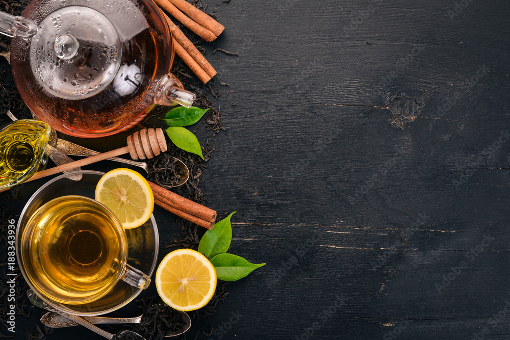 Black and green tea with lemon, honey, cinnamon and ginger. Hot drink Top view. Copy space.