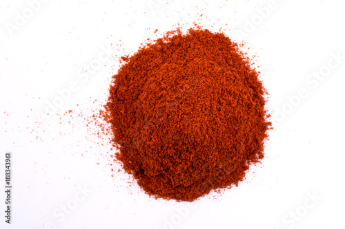 A pile of a dry red paprika powder isolated on white background