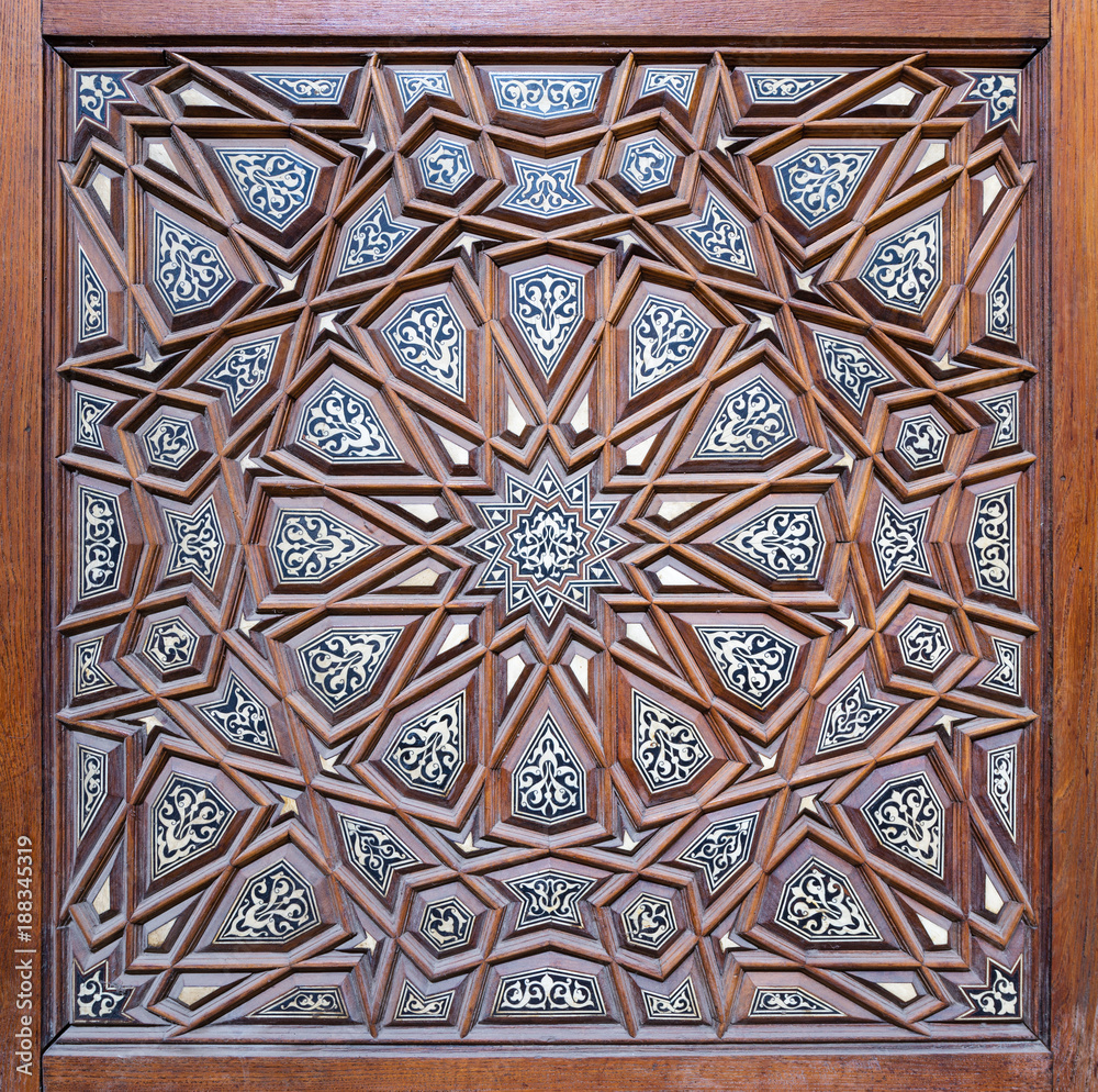 Closeup of arabesque ornaments of an old aged decorated wooden door