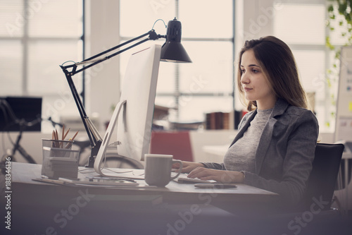 Working woman in front of computer photo