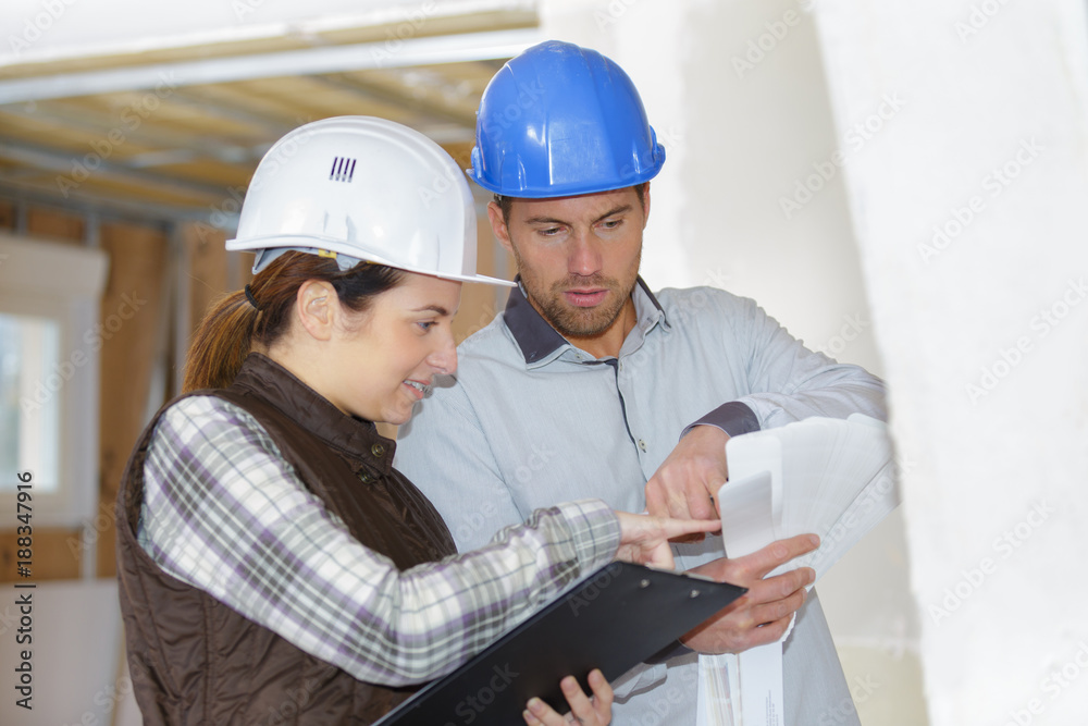 cheerful architects with blueprints cheerful architects with blueprints