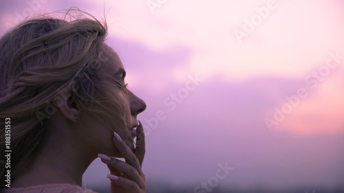 Beautiful lady sadly recollecting sweet kisses of beloved boyfriend on her lips photo