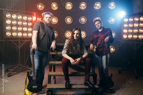 Photography Musical group poses on the stage in night club