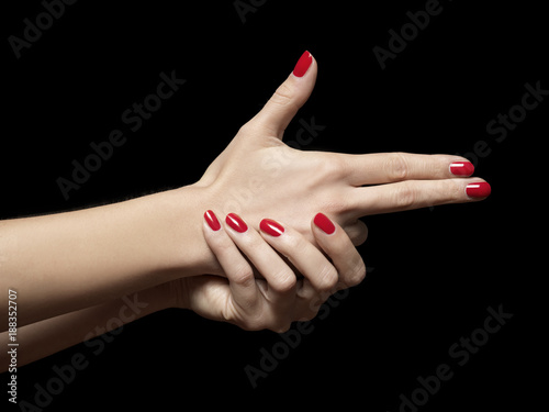 close-up female manicured hands pretending to pistol bang shoot photo
