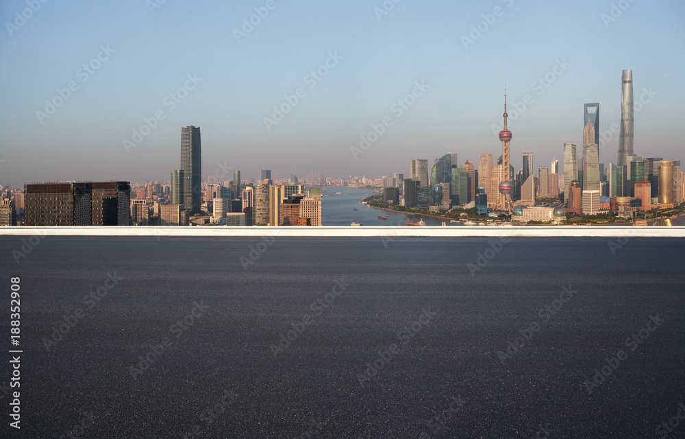 Empty road floor surface with city landmark buildings at Shanghai Skyline
