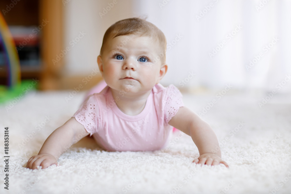 Portrait of baby girl in white sunny bedroom. Newborn child learning crawling. Portrait of baby girl in white sunny bedroom. Newborn child learning crawling.