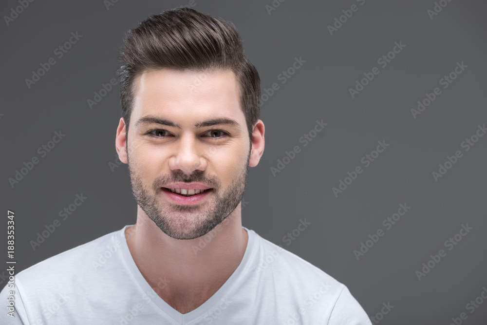Fototapeta premium portrait of handsome smiling bearded man, isolated on grey