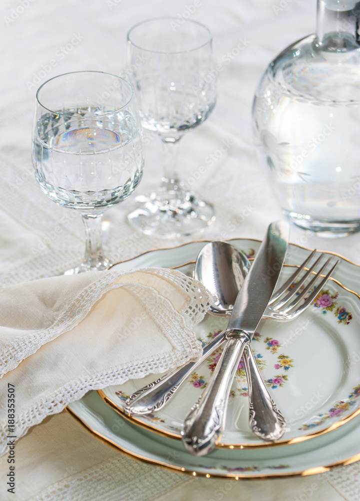 Elegant dinner set with silver knife, fork and spoon lying across