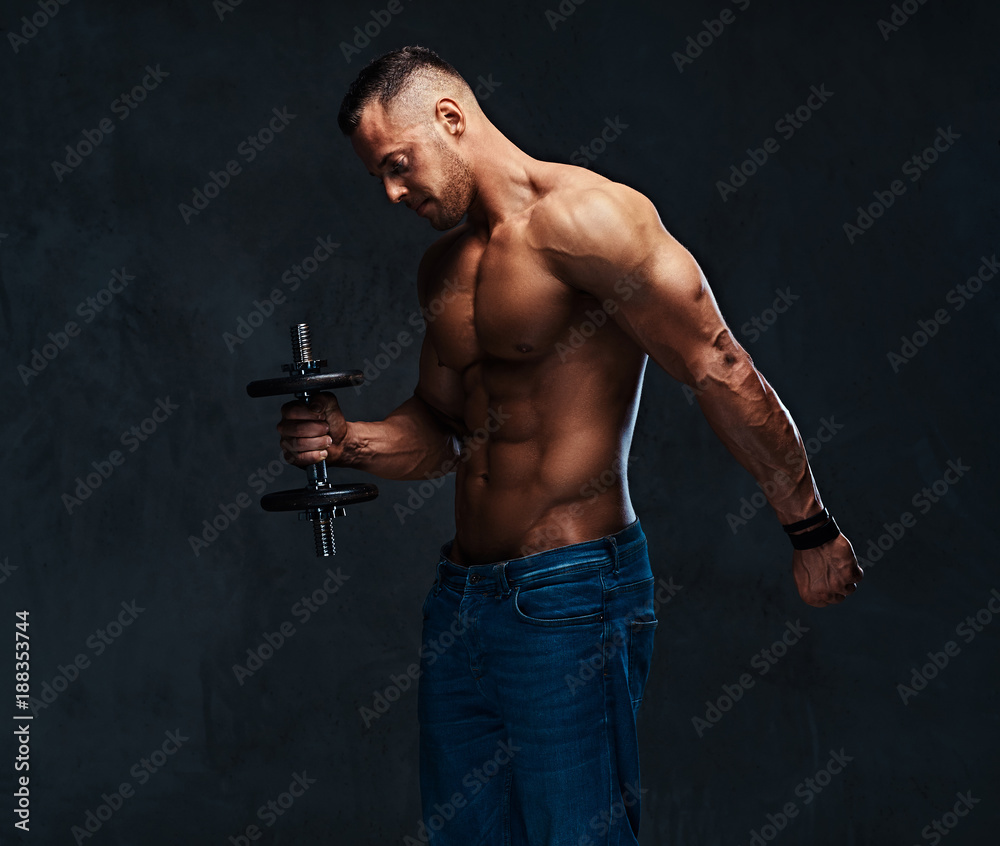 Athletic shirtless male biceps dumbbell workout.