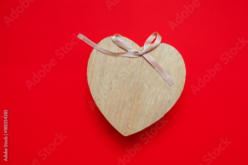 Valentine's day gift for the second half, a romantic photo, a wooden heart on a red background, suitable for text insertion, photo