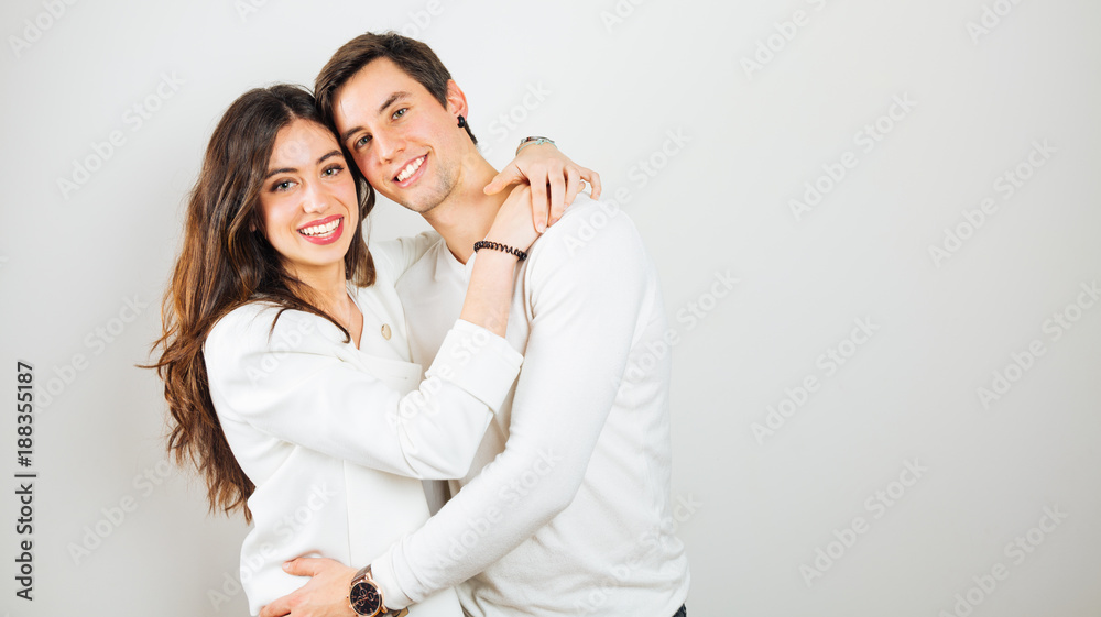 Happy young couple embracing on a white background Happy young couple embracing on a white background