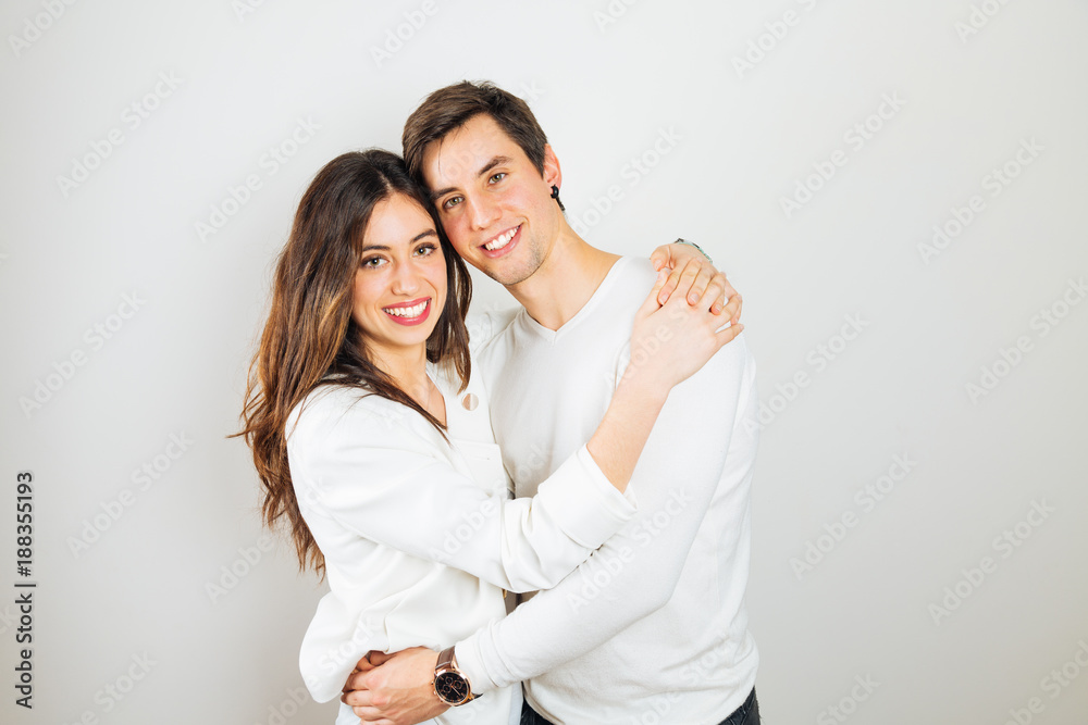 Happy young couple embracing on a white background Happy young couple embracing on a white background