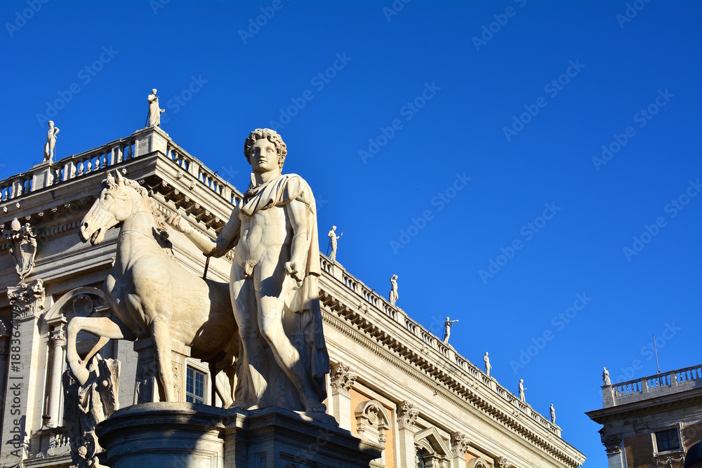 Marble statues of the Dioscuri, Castor and Pollux, at the top of the staircase, with Capitol Square or Piazza del Campidoglio in background. Rome, Italy.