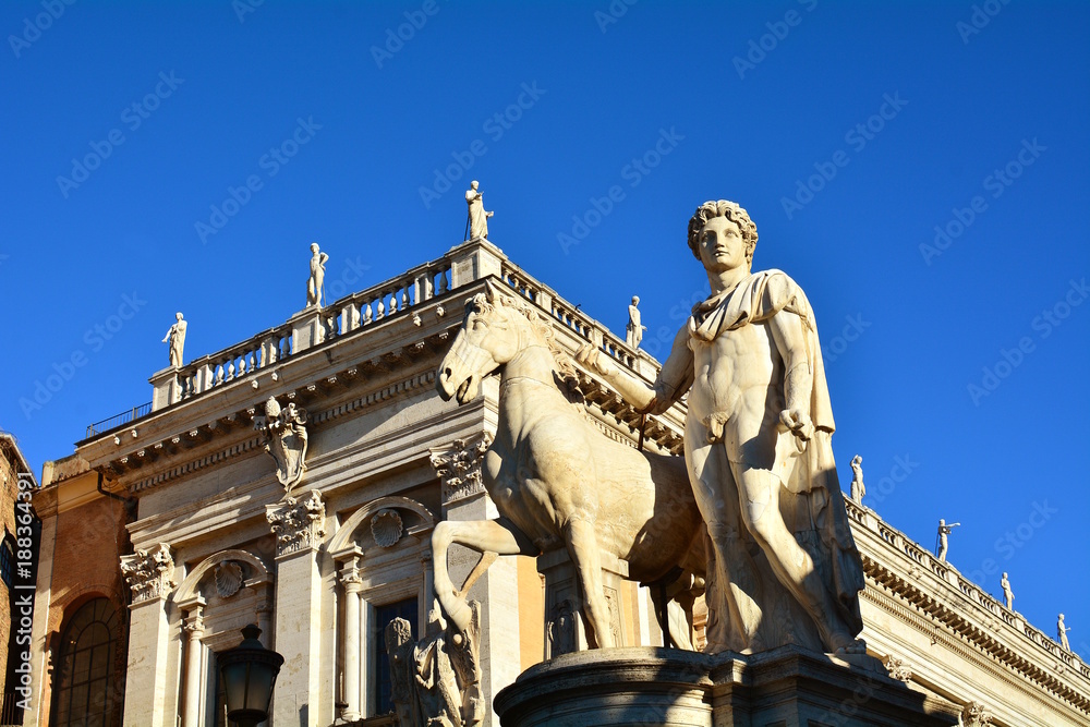 Marble statues of the Dioscuri, Castor and Pollux, at the top of the staircase, with Capitol Square or Piazza del Campidoglio in background. Rome, Italy.