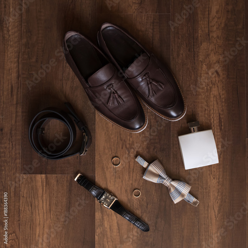 Wedding details. Groom accessories. Shoes, rings, belt, and bowtie