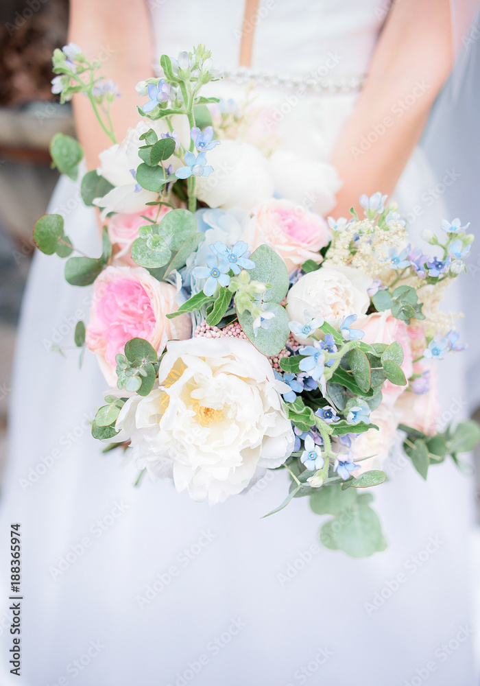 Rich colorful wedding bouquet in bride's hands