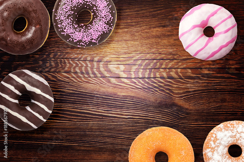 Assorted donuts on wooden background