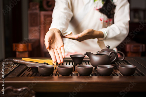 Woman offering traditionally prepared Chinese tea
