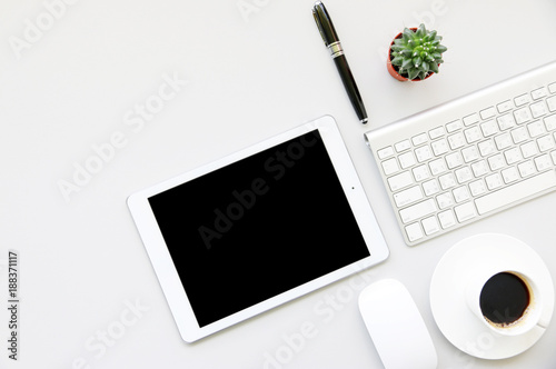 Office table with tablet,smartphone,pen,coffee cup and cactus, copy space,Top view, flat lay