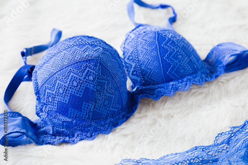 Stylish, blue lace bra on fluffy blanket in morning. Women sexy underwear. Surprise for men. Romantic lingerie for Valentine's day or first wedding also daily temptation. Stock-foto Adobe